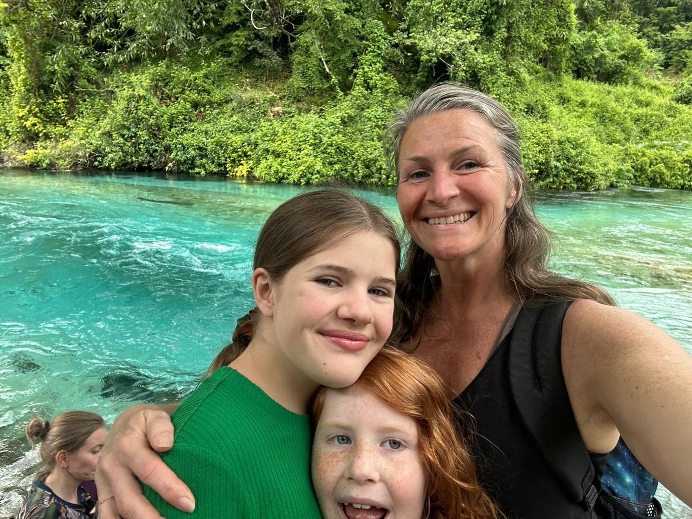 Maya Lila Di Vento with her two daughters beside the turquoise Blue Eye spring in Albania